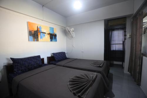 a small room with two beds and a couch at Funky Crab The River in Krabi