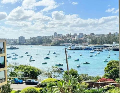a view of a harbor with boats in the water at Waterfront Bliss Apartment in the Heart of Manly in Sydney