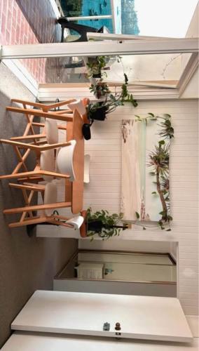 a room with a bunch of plants on the wall at Waterfront Bliss Apartment in the Heart of Manly in Sydney