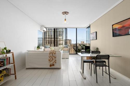 a living room with a couch and a table at Ocean view apartment close to CBD with indoor pool. in Melbourne
