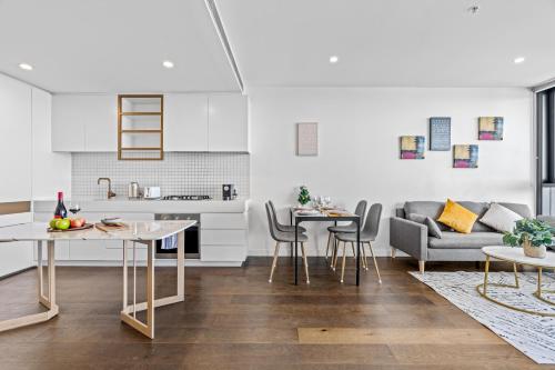 Galleria on the Glen - High floor deluxe apartment في غلين وافرلي: مطبخ وغرفة معيشة مع أريكة وطاولة