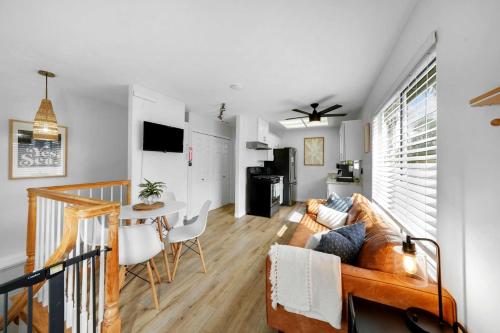 a living room with a couch and a table at Beacons Beach Cottage in Encinitas