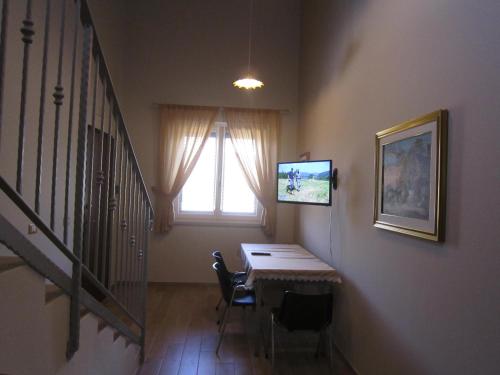 a dining room with a table and a window at La Radice in Paganica