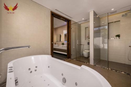 a large white bath tub in a bathroom at The Five Stars Villa 7 Bedrooms Beachfront in Danang