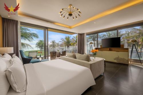a bedroom with a large bed and a living room at The Five Stars Villa 7 Bedrooms Beachfront in Danang