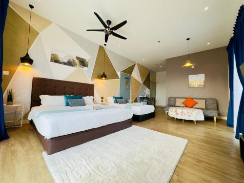 a large bedroom with two beds and a couch at Owl Nest Suite' at aeropod sovo in Kota Kinabalu