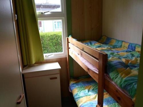 a small bedroom with a bed and a window at Chalet 3 Chambres avec Terrasse - Parfait pour 6 Personnes - API-1-52-991 in La Chapelle