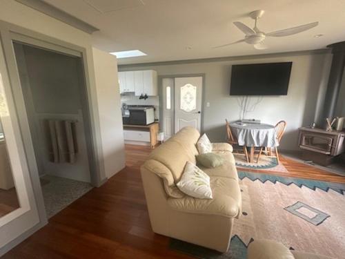 a living room with a couch and a table at Quiet Rural Retreat - Kimbriki in Mount George