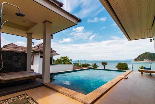 a swimming pool in the backyard of a house at Sunset bay view villa krabi in Ban Khao Thong