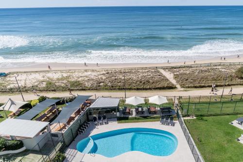 an overhead view of a pool and the beach at The Breakers in Gold Coast