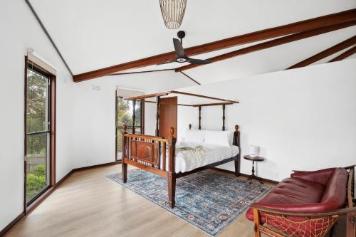 a bedroom with a bed and a couch at Clifton Retreat large family home new renovation in Clifton Springs