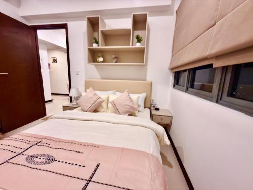 a bedroom with a large bed and a window at Trizen Colombo stylish high rise condo -Vistablu 32 in Colombo