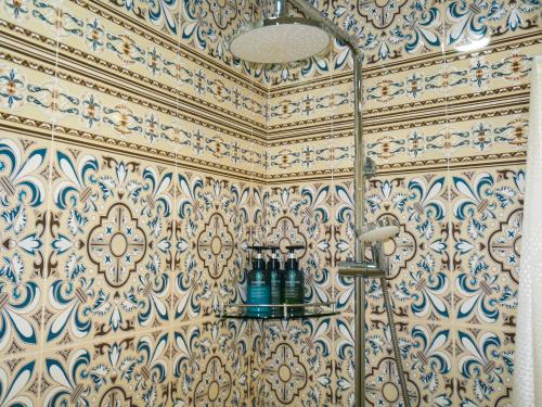 a bathroom with a shower with blue and white tiles at Oasis Boutique in Bukhara