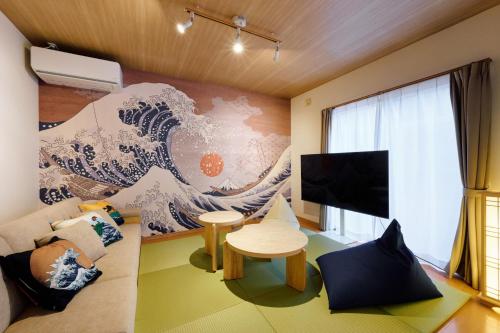 a living room with a mural of a wave at Oneness House Kumamoto2 熊本新町2 in Kumamoto