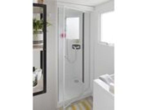 a white bathroom with a shower and a mirror at Mobil-home cosy avec terrasse pour 5 personnes - API-1-52-1066 in Saint-Rome-de-Tarn