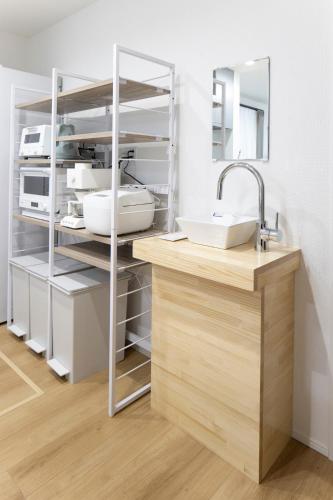 a kitchen with a sink and a counter at T-Tarry Stay Villa in Sapporo