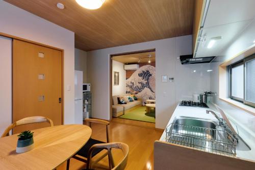 a kitchen and dining room with a table and a sink at Oneness House Kumamoto2 熊本新町2 in Kumamoto