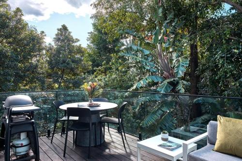 a patio with a table and chairs on a balcony at Bondi Beach Premium Hideaway - Premium 2 bed apartment in Sydney