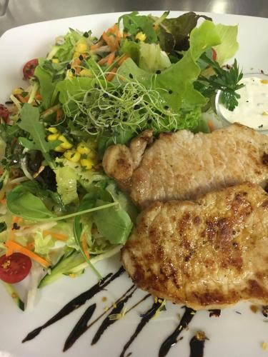 a plate of food with a salad and meat at Landgasthof Rössle ** Superior in Ruggell