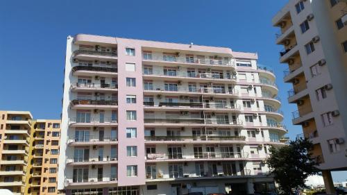 un edificio de apartamentos alto y blanco con balcones en Apartment Siracuza Mamaia Nord, en Mamaia