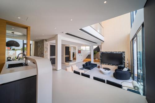 a living room with a couch and a tv at Bangtao New Luxury 7 Bedrooms Modern Space Aesthetic Design Private Pool Villa Private Movie Theater in Ban Nong Chaeng