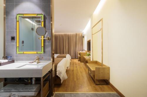 un bagno con lavandino e specchio di James Joyce Coffetel Qufu Tourist Center Gulou Street Sankong Scenic Spot a Qufu