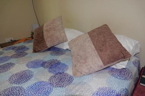 En eller flere senge i et værelse på San Cristóbal Surfing House