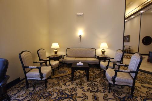 a living room with a couch and chairs and a table at Awaliv Hotel in Taif