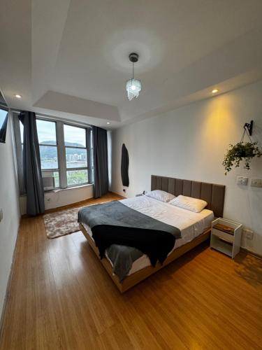 a bedroom with a large bed and a large window at Tribo Rio in Rio de Janeiro