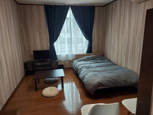 Postel nebo postele na pokoji v ubytování プレストン筒井