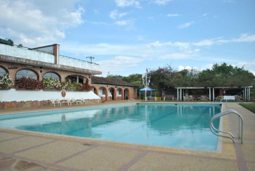 a large swimming pool in front of a building at Hotel Acuarela in La Granja