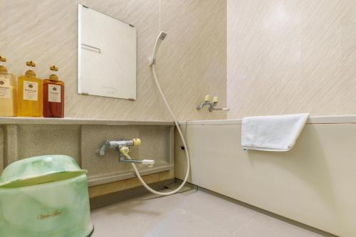 a bathroom with a hose hooked up to a faucet at Hotel KOYO Bekkan - Vacation STAY 37061v in Hashima