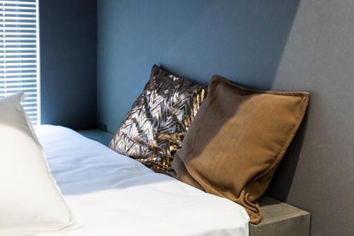 a bedroom with a bed with a pillow on it at Amp Flat 清川 in Sumiyoshi