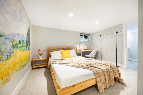 a bedroom with a bed and a painting on the wall at Renton DT 1BR Suite WS 95 Near Landing &Sea-Tac in Renton