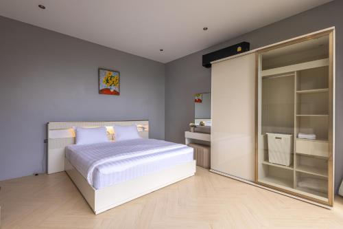 a bedroom with a white bed and a glass door at Escape Villa 2-Bedroom Luxury Retreat with Private Pool & Sea View in Mae Haad