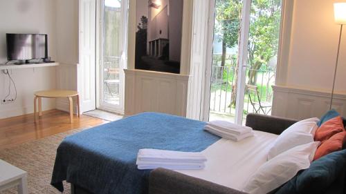 a living room with a table with towels on it at Koolhouse Porto in Porto