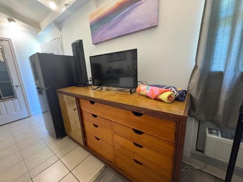 a dresser with a television on top of it at Rainbow Ohana, unit 2 in Hilo