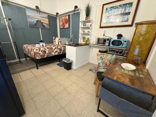 a living room with a bed and a table at Rainbow Ohana, unit 2 in Hilo