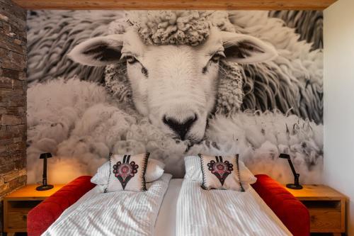 a mural of a sheep on a wall at Janiołów Wierch 43 Jacuzzi i Sauna in Groń