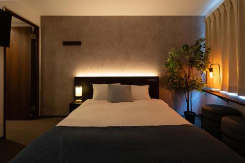 Ένα ή περισσότερα κρεβάτια σε δωμάτιο στο Residence Hotel Sapporo Susukino