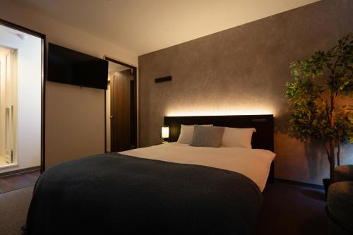 Ένα ή περισσότερα κρεβάτια σε δωμάτιο στο Residence Hotel Sapporo Susukino