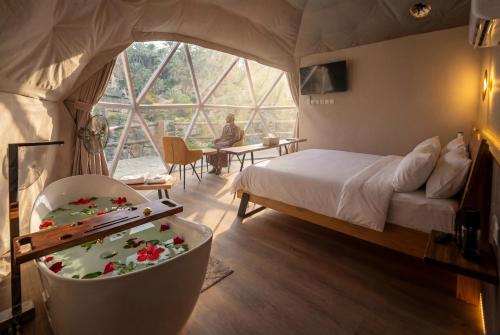 sypialnia w namiocie z łóżkiem i stołem w obiekcie Rabwa Geodesic Dome w mieście Misfāh
