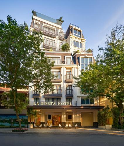 a large white building with a sign on it at La Siesta Premium Lakeside in Hanoi