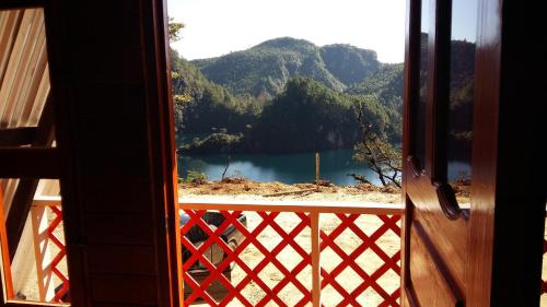 a view of a lake from a room with a window at Cabañas Cinco Lagos in Santiago