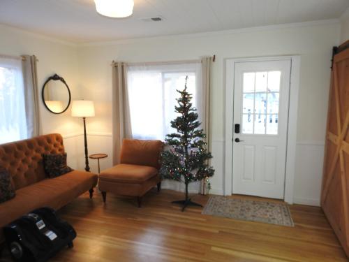 a living room with a christmas tree and a couch at Miners Choice 3 Bedroom on Main St Bonus Rooms Sleeps up to 9 TV WIFI Piano in Julian