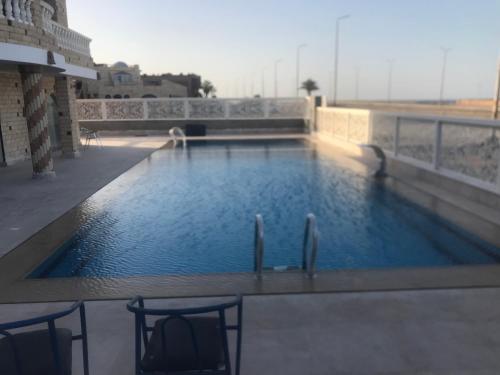a swimming pool on the roof of a building at Rock House in Marsa Alam City