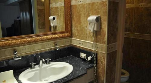 a bathroom with a sink and a mirror at Subic Bay Venezia in Olongapo