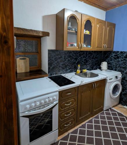a kitchen with a stove and a sink at National Monument Konak in Stolac