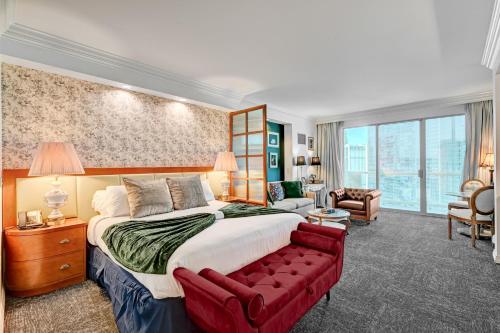 a bedroom with a large bed and a red couch at Vintage Lair STUDIO Balcony F1 SPHERE VIEW Tower 3 in Las Vegas