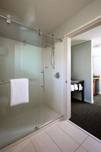a bathroom with a shower with a glass door at Hyatt House Seattle/Redmond in Redmond